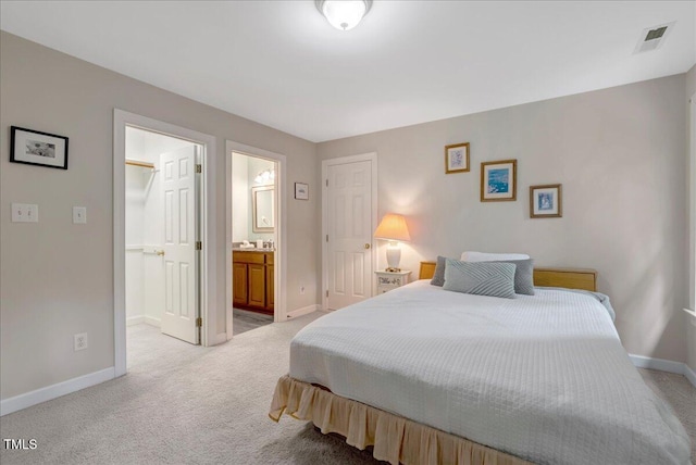 bedroom featuring baseboards, light carpet, and a closet