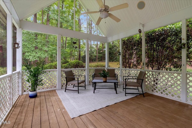 sunroom with a ceiling fan and vaulted ceiling