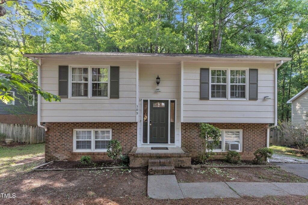 309 Penn Oak Cir, Raleigh, NC 27615 - split foyer home featuring fence, brick siding, and cooling unit