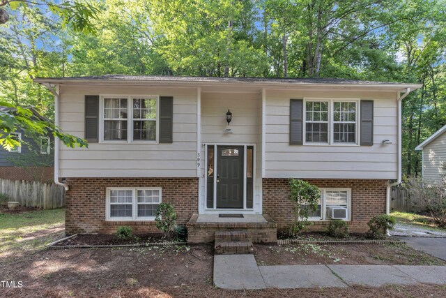 309 Penn Oak Cir, Raleigh, NC 27615 - split foyer home featuring fence, brick siding, and cooling unit