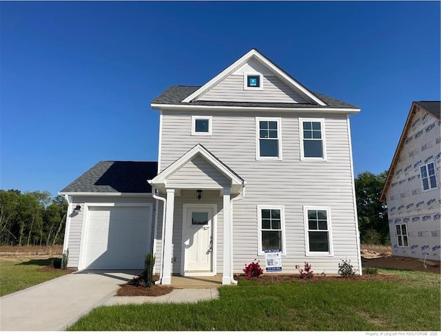 228 Peeler Cir, Raeford, NC 28376 - traditional-style home with a garage, driveway, and a front yard