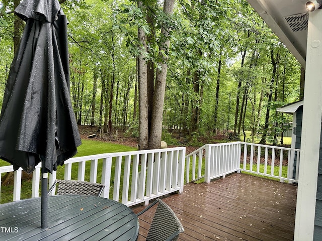 wooden terrace featuring outdoor dining area