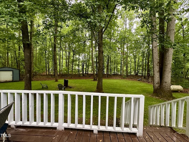 wooden terrace with a yard, an outbuilding, and a storage unit