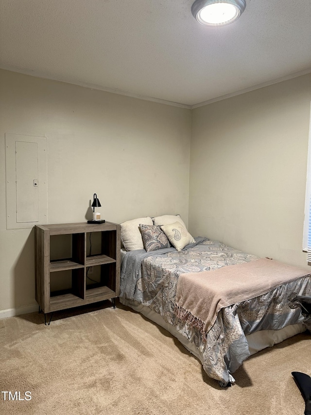 bedroom with carpet flooring, electric panel, and ornamental molding