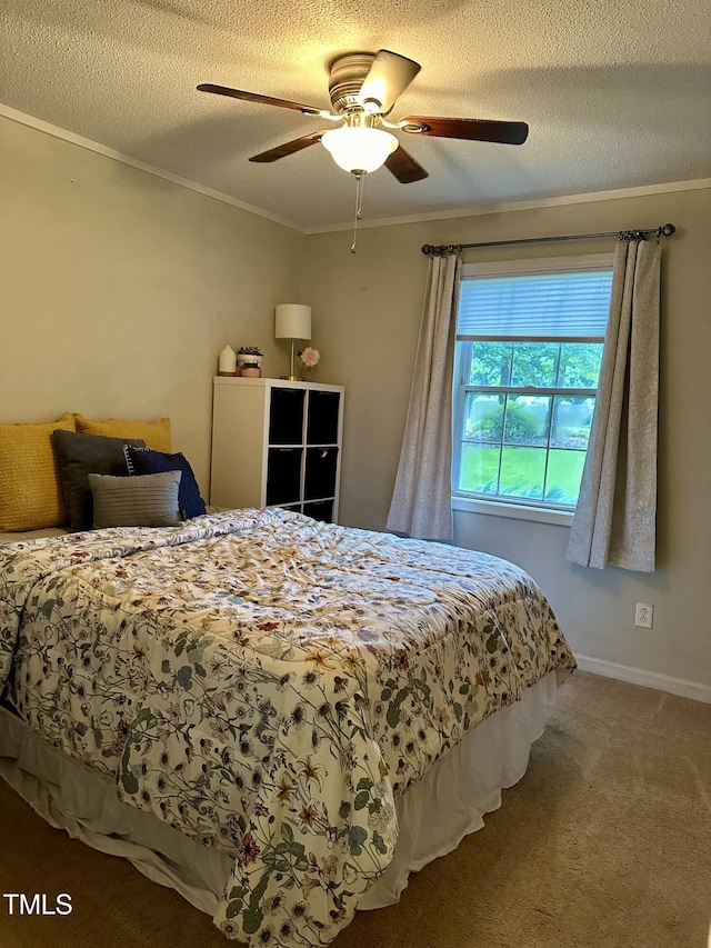 bedroom with ornamental molding, carpet floors, a textured ceiling, a ceiling fan, and baseboards