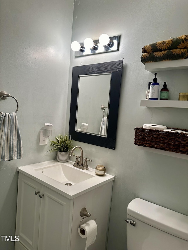 half bath featuring toilet and vanity