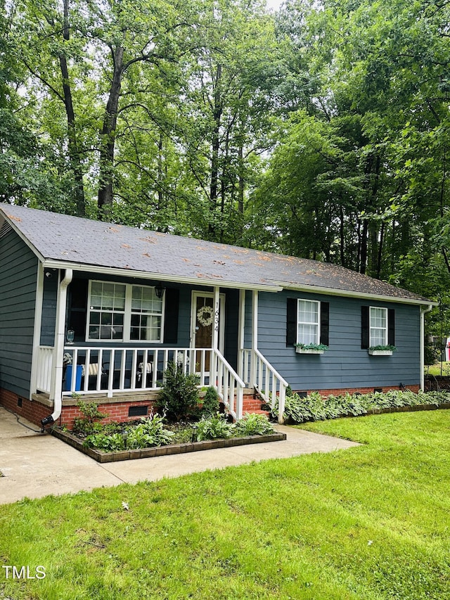 ranch-style house with a front yard, crawl space, and covered porch
