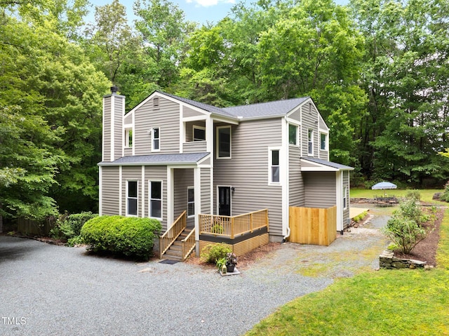 406 Johns Woods Rd, Chapel Hill, NC 27516 - view of front of home with a chimney, a wooden deck, a shingled roof, and view of scattered trees
