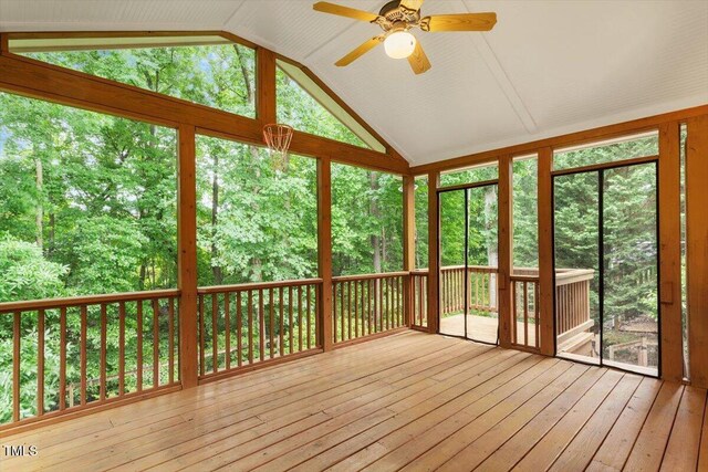 6335 Cedar Waters Dr, Raleigh, NC 27607 - unfurnished sunroom with vaulted ceiling, a deck, ceiling fan, wood-type flooring, and healthy amount of natural light