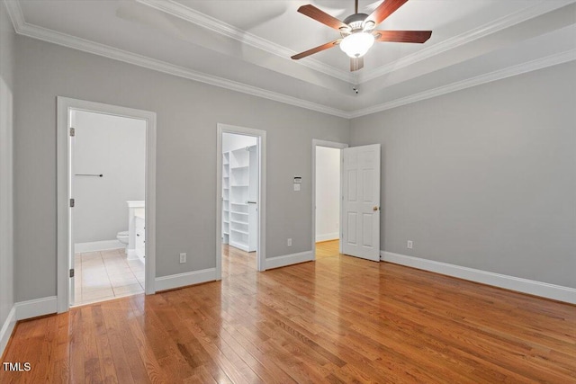 6335 Cedar Waters Dr, Raleigh, NC 27607 - unfurnished bedroom featuring a spacious closet, light wood-style floors, ornamental molding, baseboards, and a closet