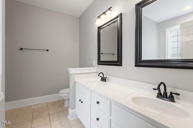 6335 Cedar Waters Dr, Raleigh, NC 27607 - bathroom with baseboards, toilet, double vanity, and tile patterned flooring