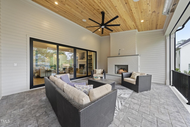 view of patio / terrace with an outdoor living space with a fireplace and ceiling fan