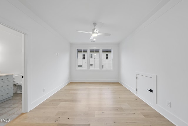 unfurnished bedroom featuring light wood finished floors, baseboards, and ceiling fan
