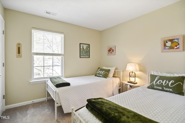 carpeted bedroom featuring multiple windows and baseboards