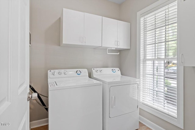 laundry room featuring cabinet space, independent washer and dryer, and baseboards