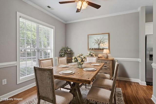 dining room with plenty of natural light, a ceiling fan, baseboards, and crown molding