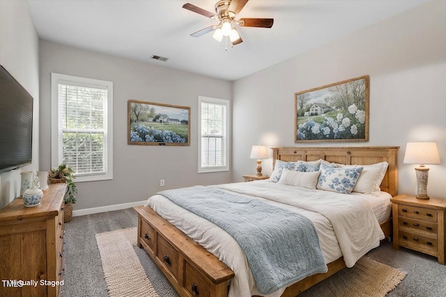 carpeted bedroom featuring baseboards and a ceiling fan