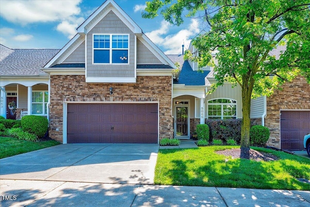 craftsman-style home with stone siding, driveway, a garage, and roof with shingles