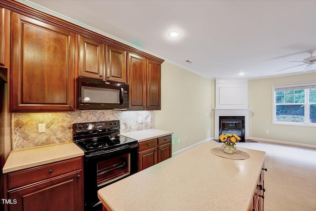 kitchen featuring black appliances, a ceiling fan, open floor plan, light countertops, and crown molding