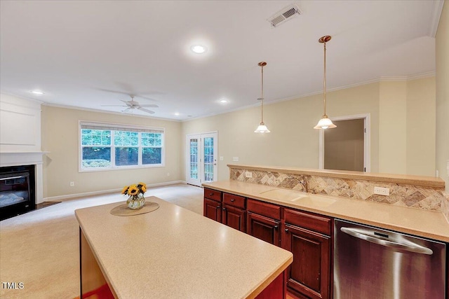 kitchen featuring dishwasher, a sink, open floor plan, ceiling fan, and light carpet