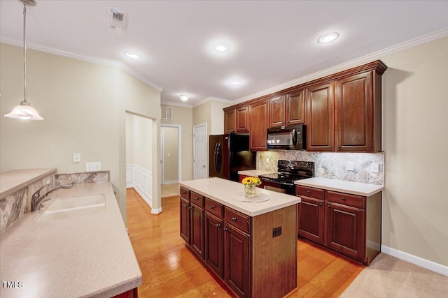 kitchen featuring black appliances, a sink, backsplash, baseboards, and light countertops