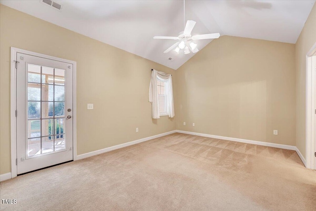 unfurnished room featuring light colored carpet, vaulted ceiling, ceiling fan, and baseboards