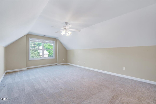 bonus room featuring carpet floors, baseboards, vaulted ceiling, and ceiling fan