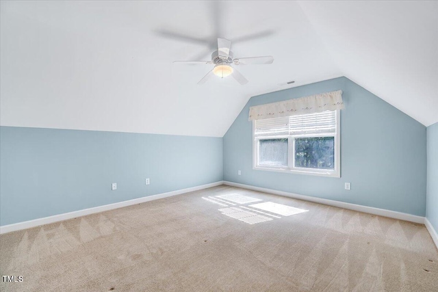 additional living space with carpet floors, a ceiling fan, baseboards, and lofted ceiling