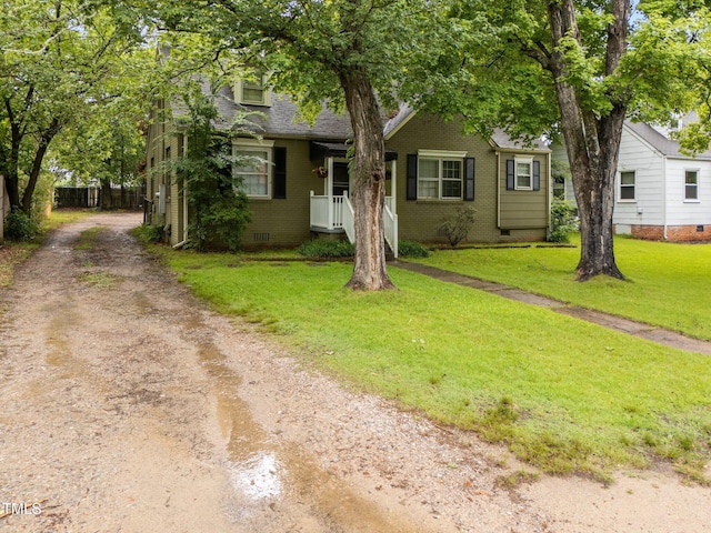 obstructed view of property with driveway, crawl space, a front lawn, and brick siding