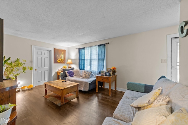 living room with a textured ceiling, wood finished floors, and baseboards