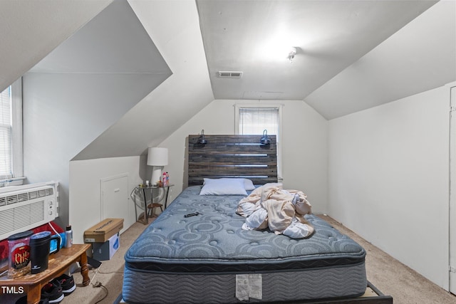 bedroom with carpet floors and lofted ceiling