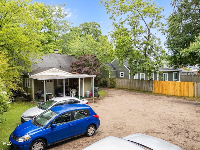 view of yard featuring fence and driveway