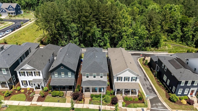 aerial perspective of suburban area featuring a heavily wooded area