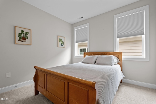 bedroom with carpet floors and baseboards