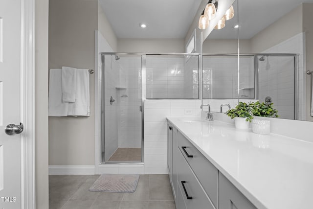 full bathroom featuring vanity, a shower stall, and tile patterned flooring
