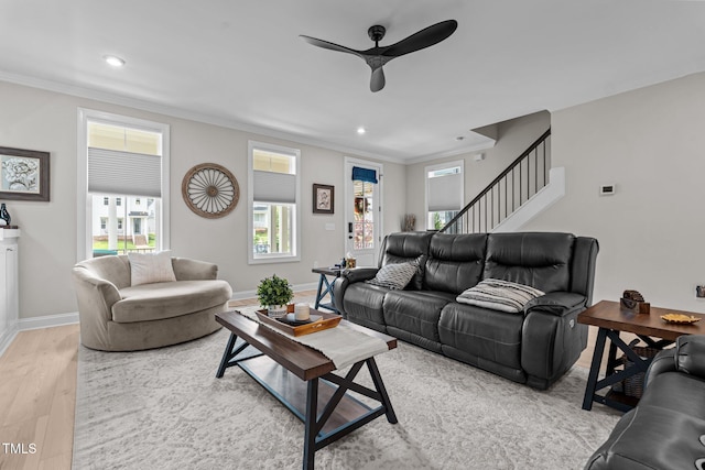 living area featuring a ceiling fan, crown molding, light wood finished floors, recessed lighting, and baseboards