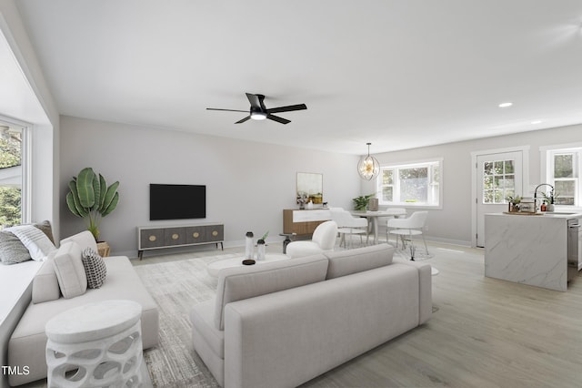 4307 Pope Rd, Durham, NC 27707 - living room with healthy amount of natural light, light wood-style floors, ceiling fan, recessed lighting, and baseboards