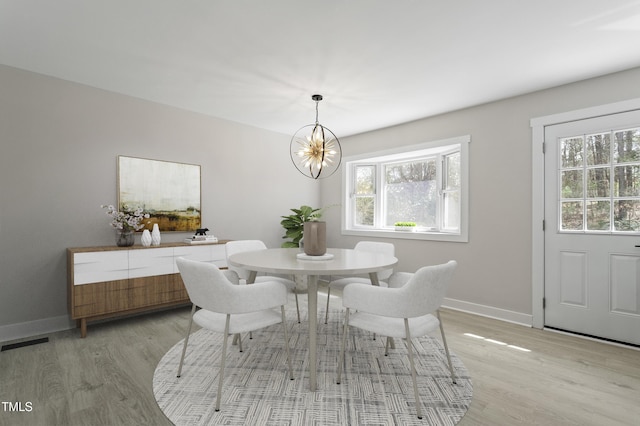 4307 Pope Rd, Durham, NC 27707 - dining area featuring light wood-type flooring, a chandelier, and baseboards