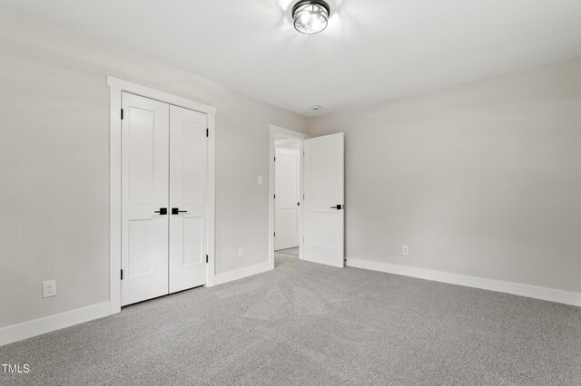 4307 Pope Rd, Durham, NC 27707 - unfurnished bedroom featuring baseboards, carpet floors, and a closet