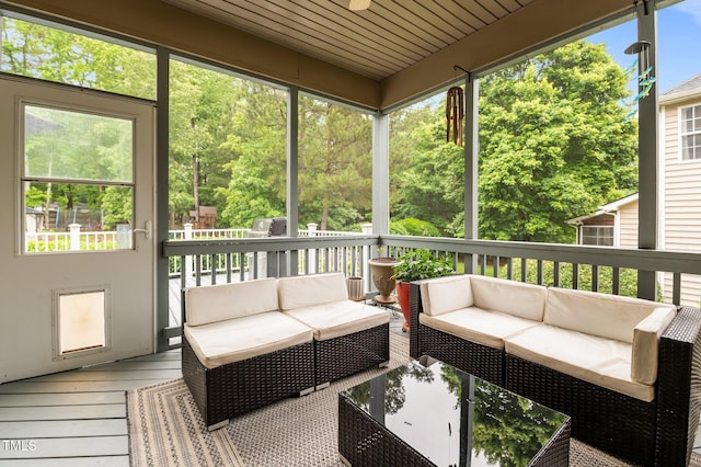 sunroom / solarium featuring outdoor lounge area and healthy amount of natural light