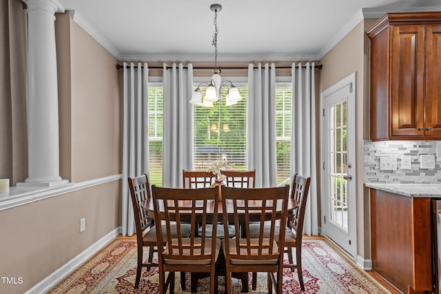 dining area featuring a chandelier, plenty of natural light, baseboards, light wood-type flooring, and ornamental molding
