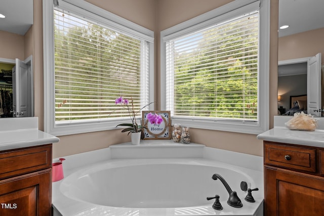 full bath with vanity and a bath