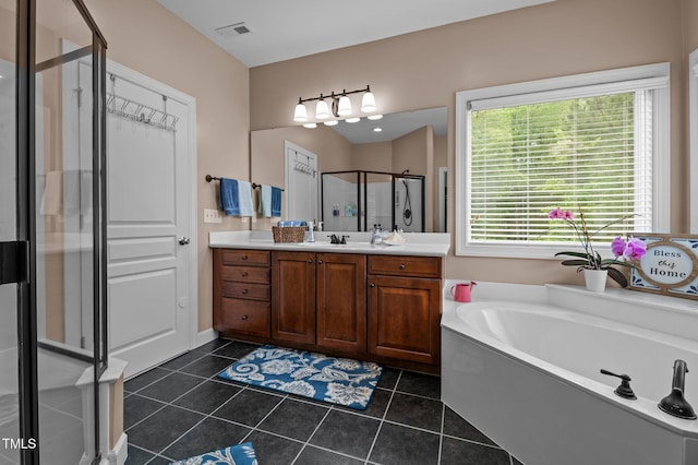 full bath with a shower stall, vanity, tile patterned flooring, and a garden tub