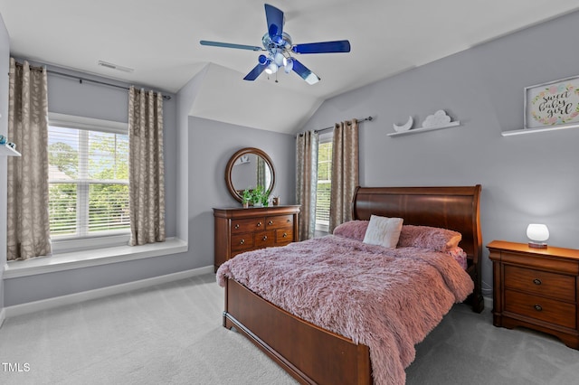carpeted bedroom with baseboards, multiple windows, lofted ceiling, and ceiling fan