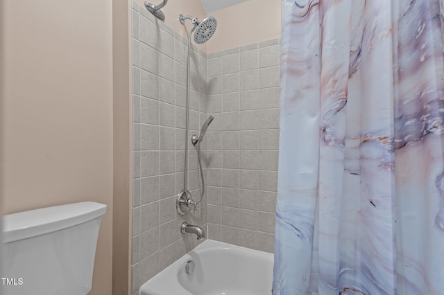 bathroom with shower / bath combination with curtain and toilet