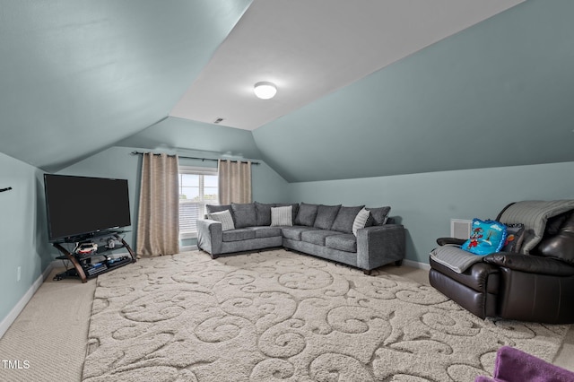 carpeted living room featuring baseboards and vaulted ceiling