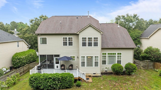 rear view of property featuring crawl space, a wooden deck, a sunroom, and a shingled roof