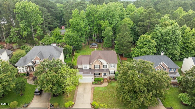 aerial perspective of suburban area with a forest