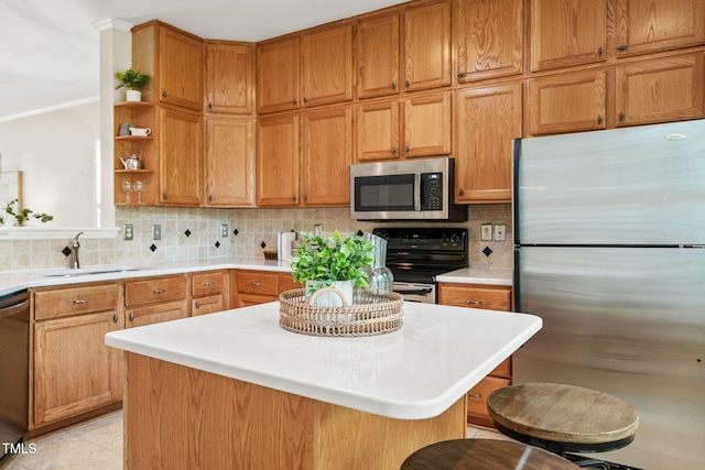 kitchen featuring appliances with stainless steel finishes, a sink, open shelves, and backsplash