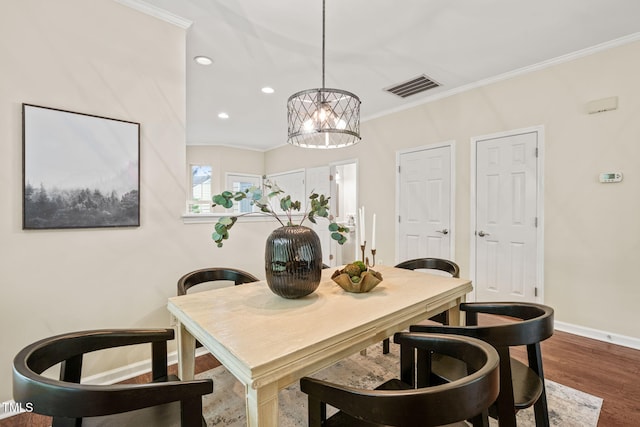 dining space featuring crown molding, baseboards, a chandelier, recessed lighting, and wood finished floors